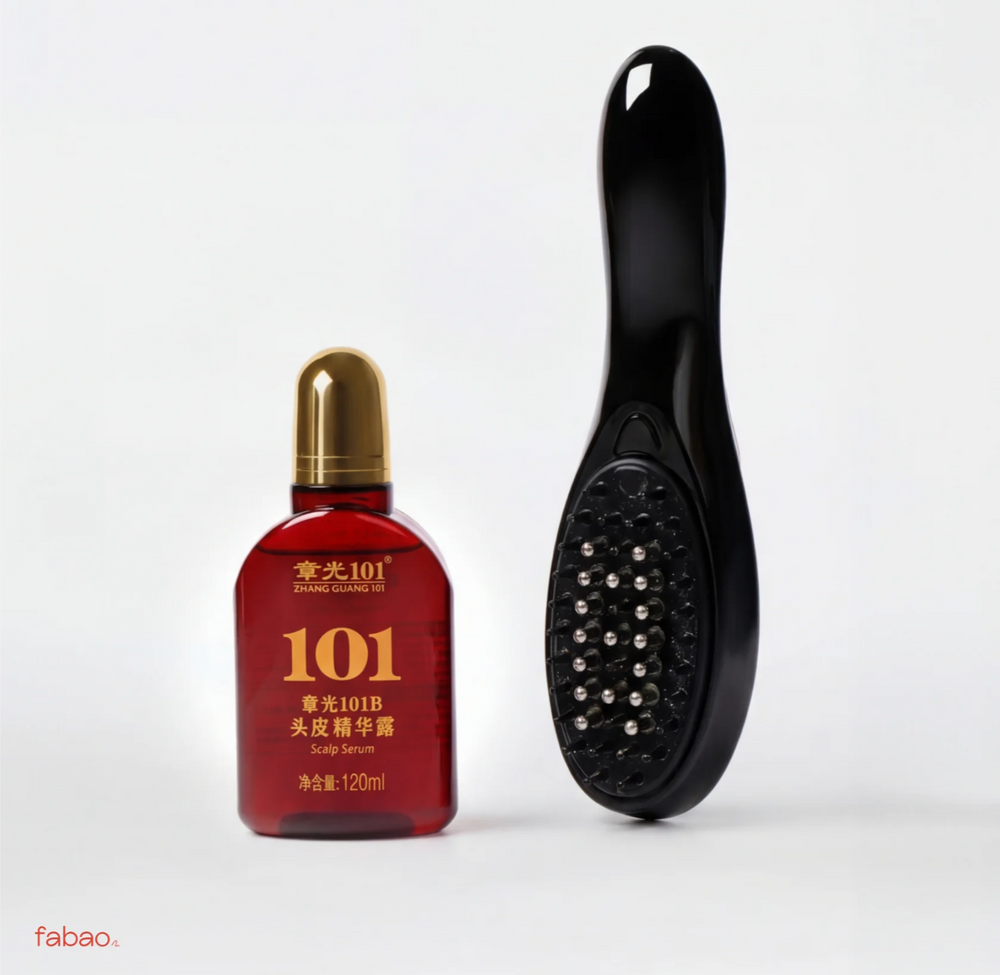 A small red bottle with a gold cap labeled 101 Scalp Serum next to a black handheld scalp massager brush on a light gray background.